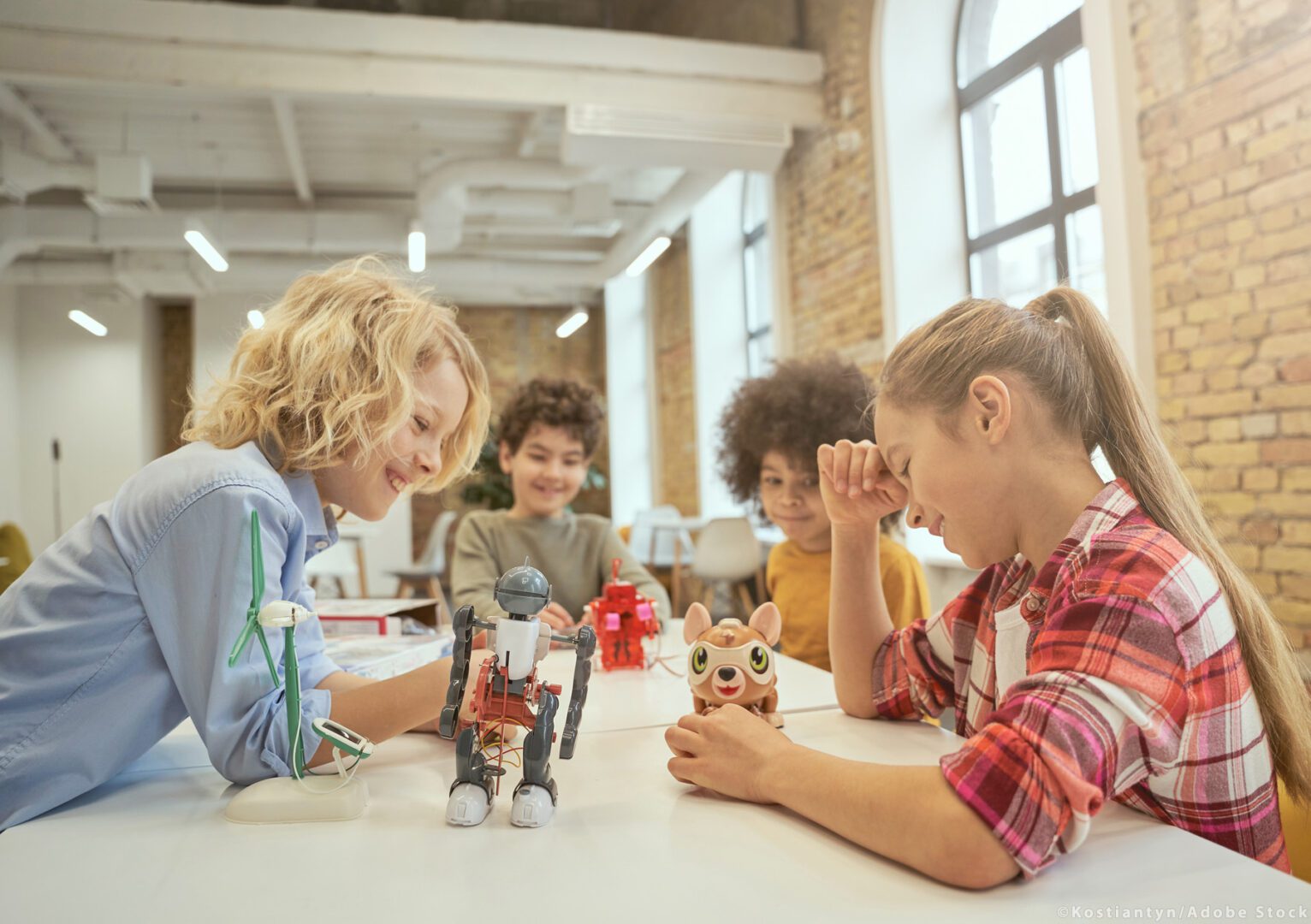 A group of kids sitting around a table.