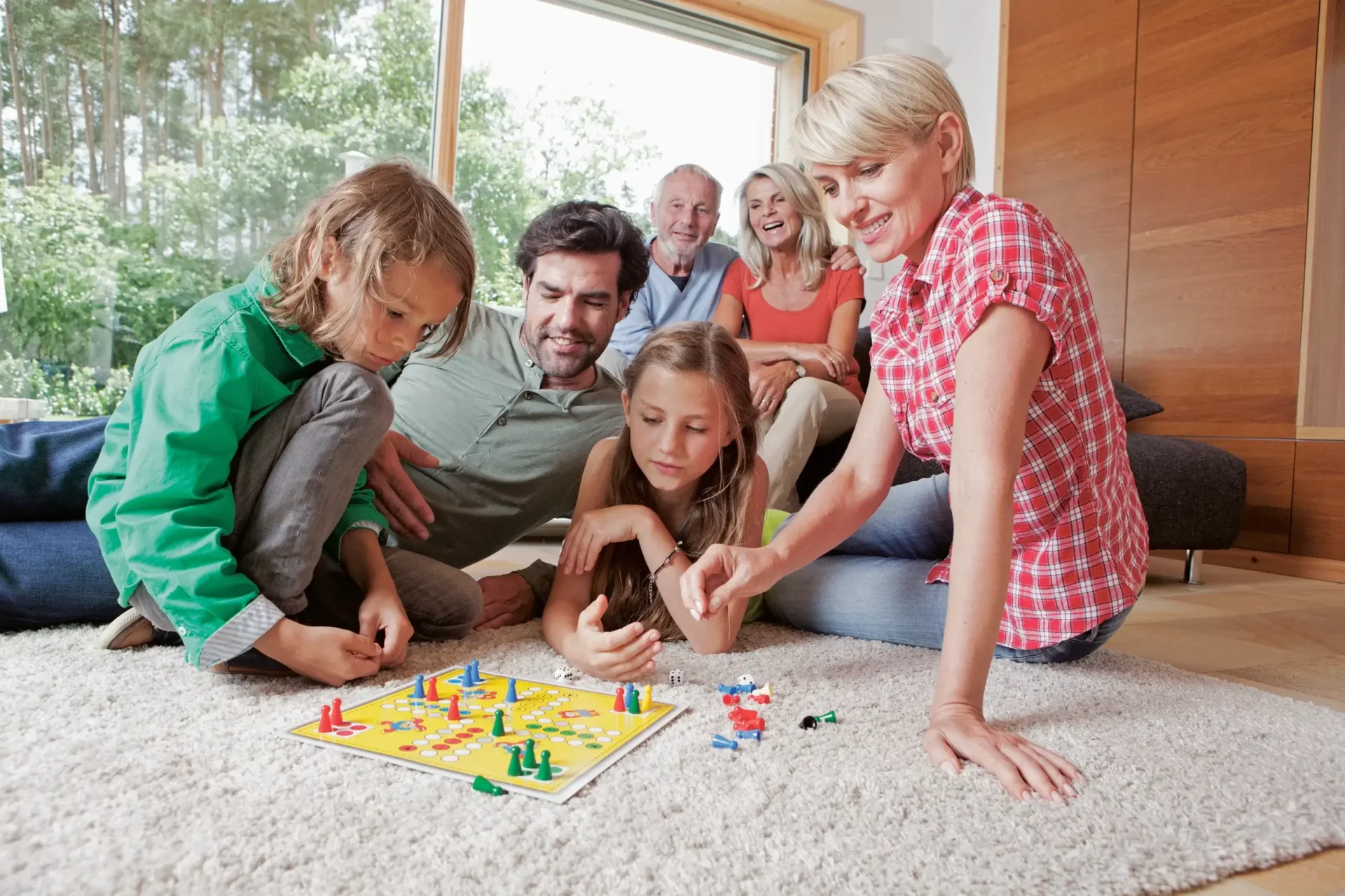 A group of people playing a board game on the floor.