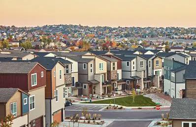 A view of some houses in the middle of a neighborhood.