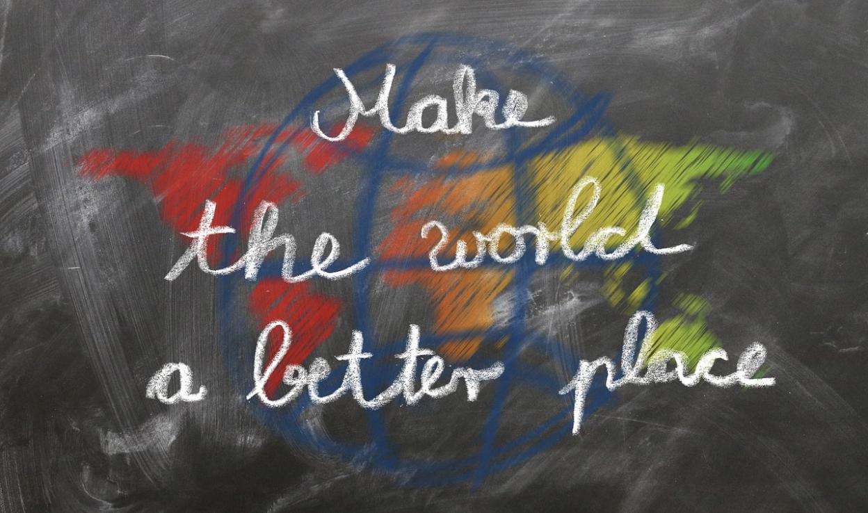 A chalkboard with the words make the world a better place written on it.