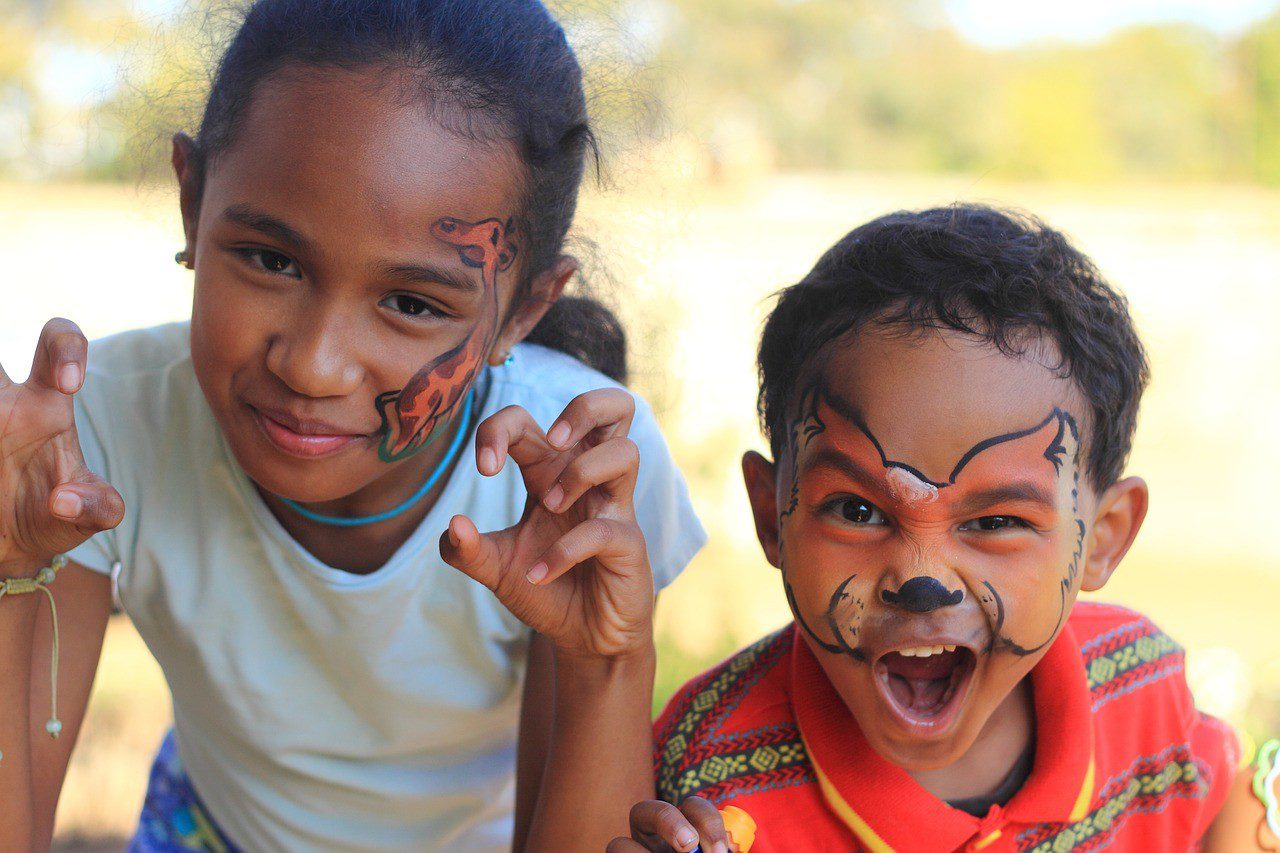 Two children with face paint on their faces.