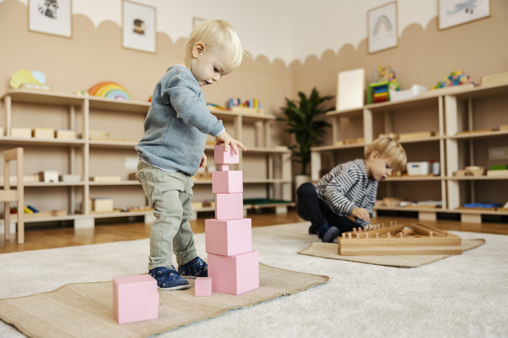 A young boy playing with blocks in a room.